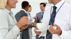 stock-footage-business-people-chatting-during-coffee-break-with-others-behind-them